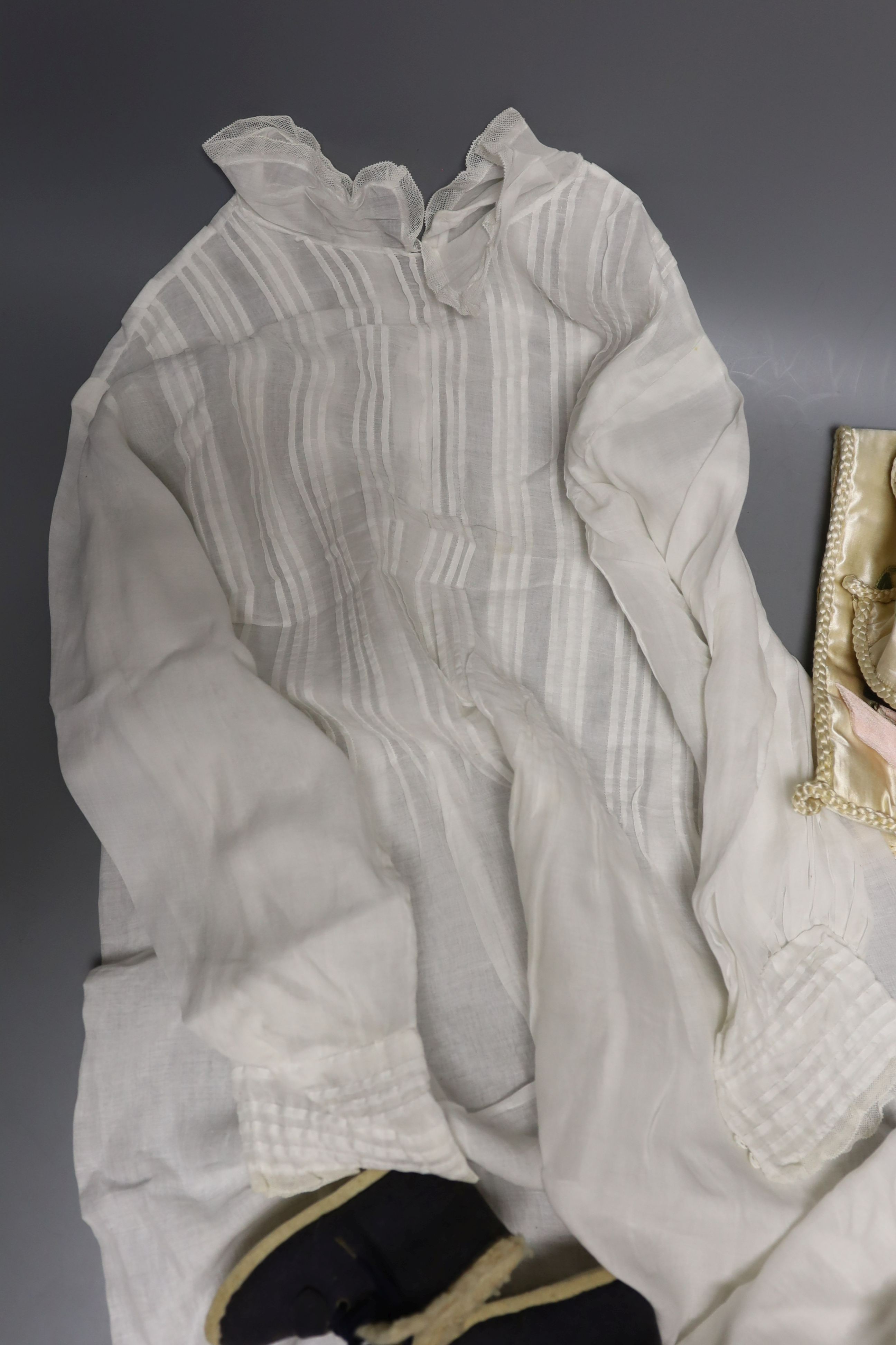 A pair of felt fur-lined child's boots and a whitework communion dress, a handkerchief sachet and two satin embroidered sachets